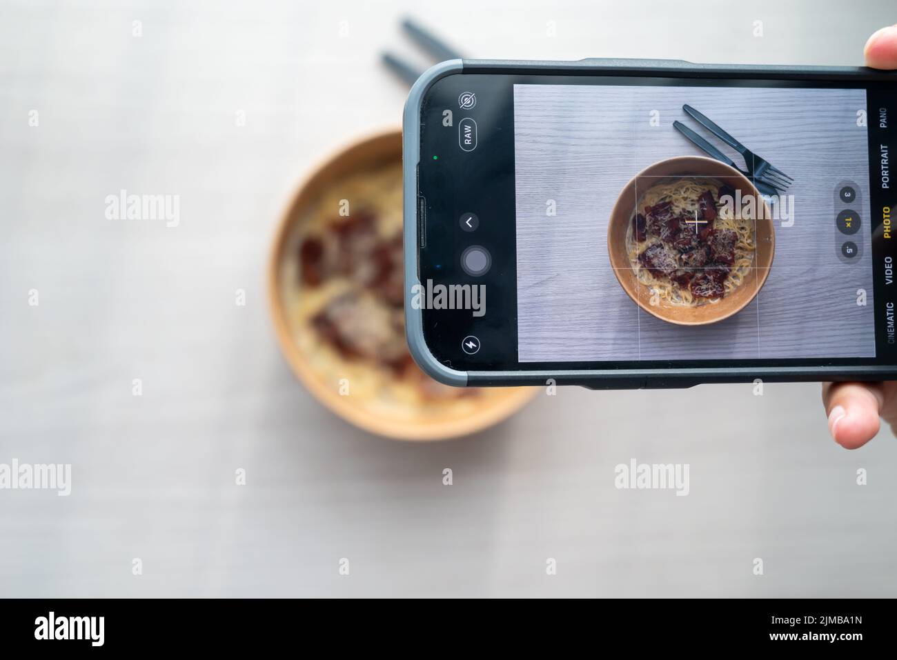Shoot first eat later concept, shooting truffle white sauce pasta top