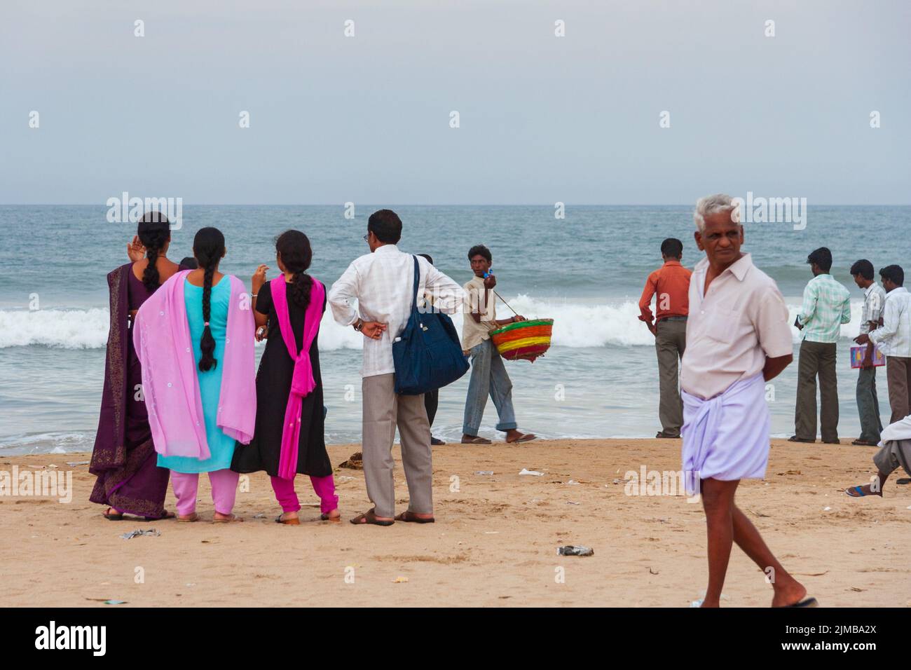 Local people enjoy themselves at the popular Marina Beach in Chennai. It is the longest beach in India situated along the coast Stock Photo