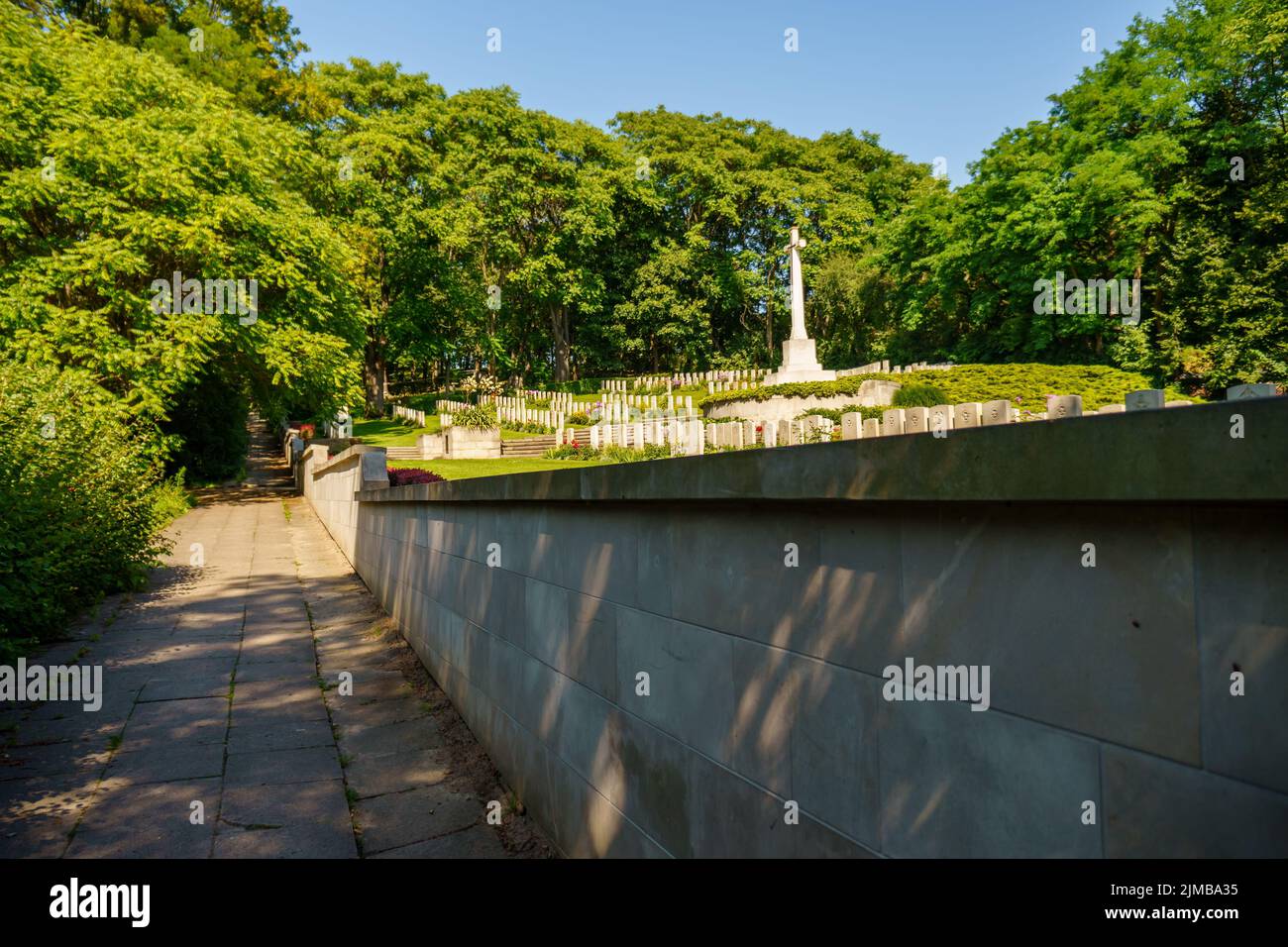 A footpath leading to the second world war graveyard with fallen soldiers in the Cytadela park Stock Photo