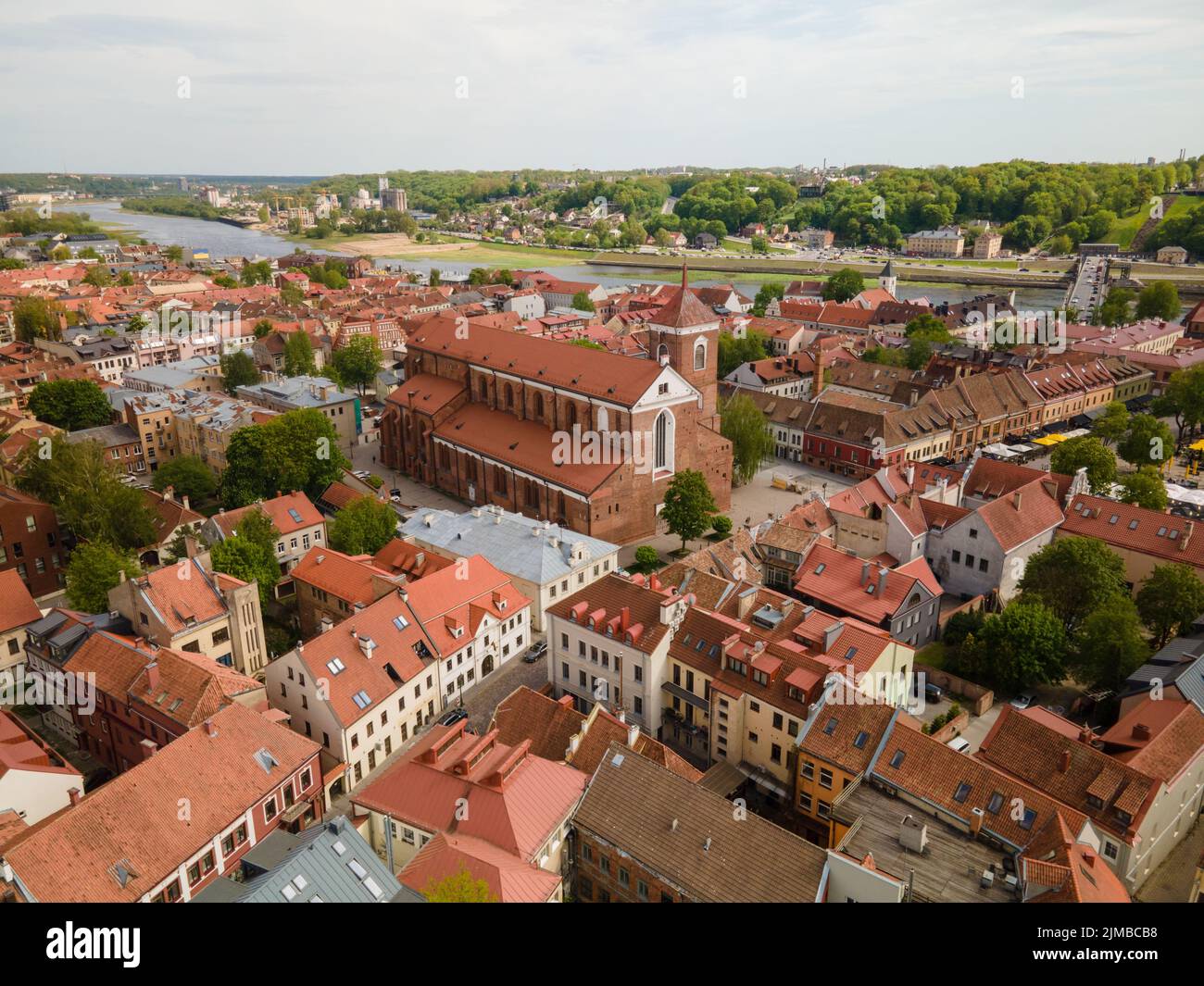 A high-angle shot of the Cathedral Basilica in Kaunas, Lithuania with other buildings around Stock Photo