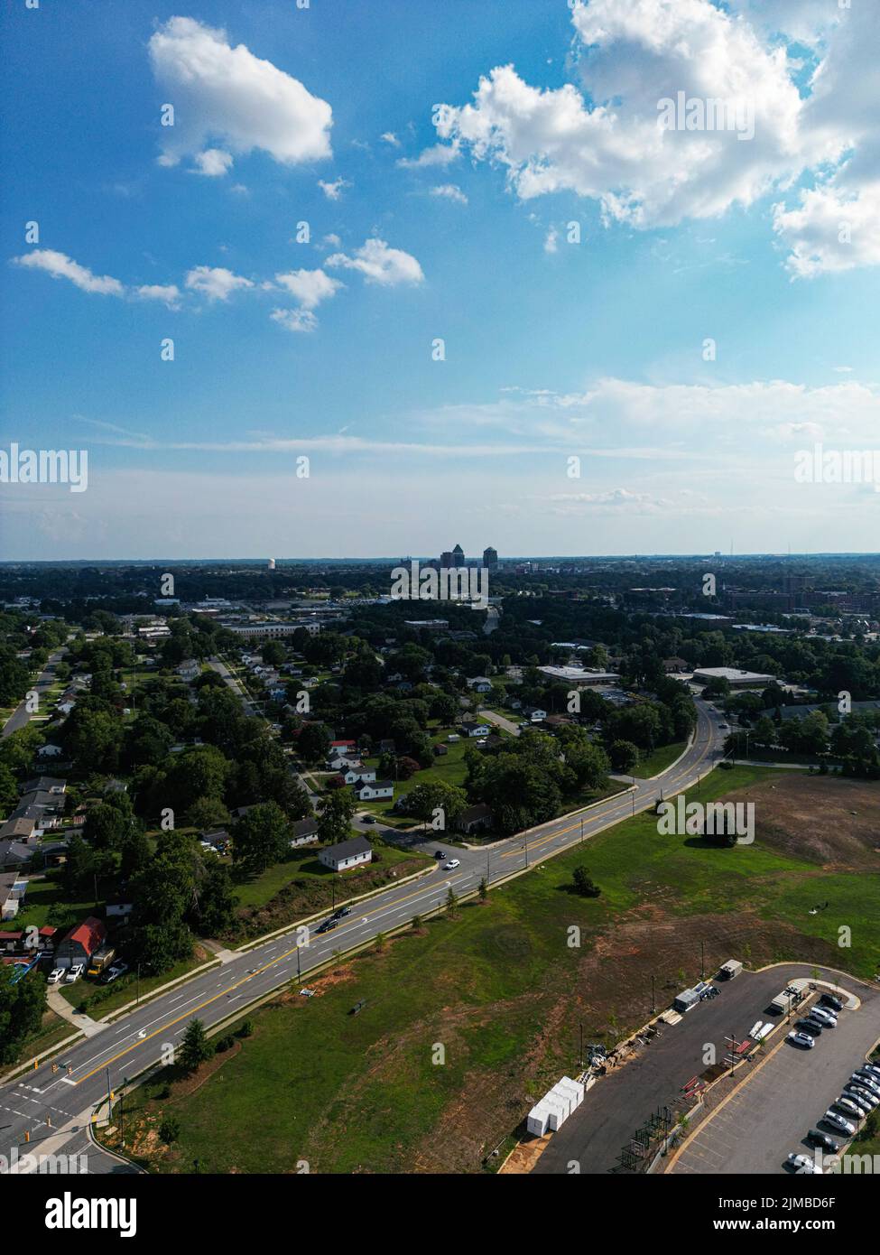A vertical aerial shot of Greensboro city in North Carolina on a partly sunny afternoon in the summer Stock Photo