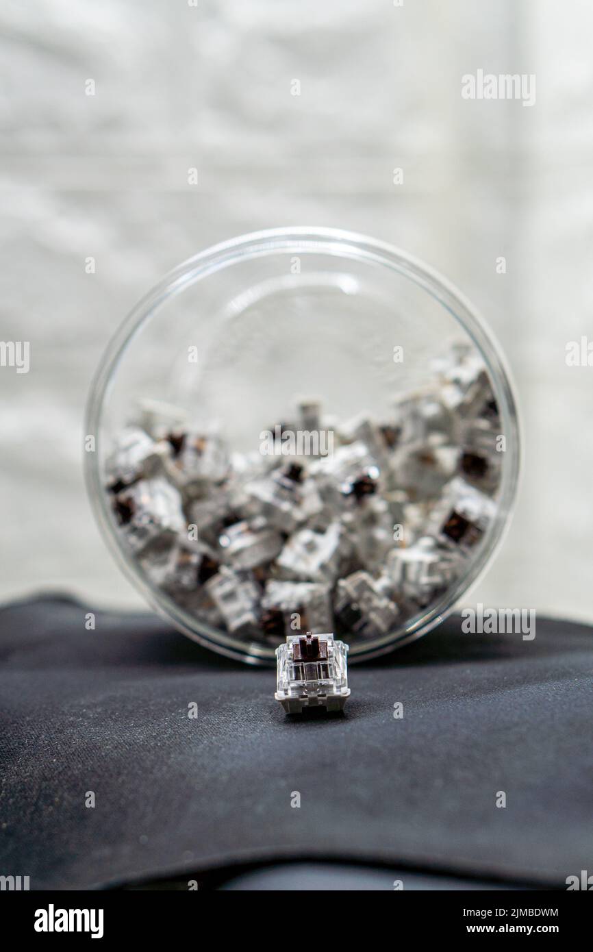 A vertical closeup of mechanical keyboard switches piled in a
