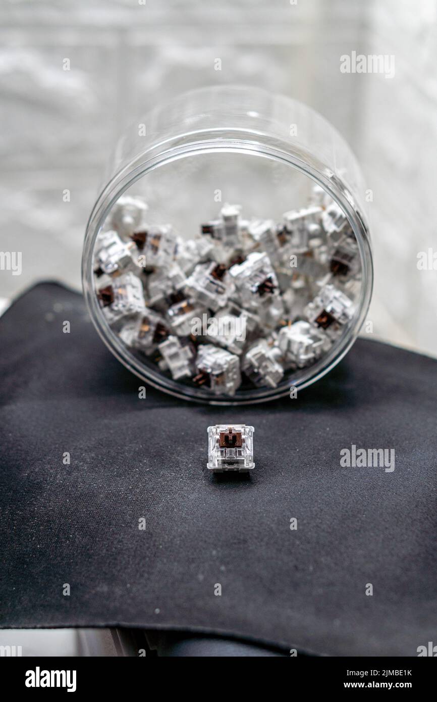 A vertical closeup of mechanical keyboard switches piled in a
