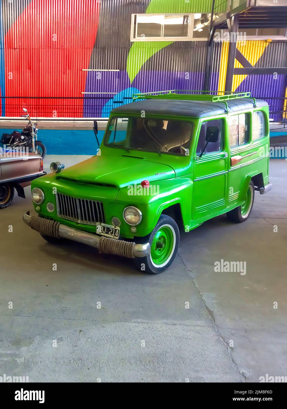 old green jeep IKA Estanciera ex Overland Willys Station Wagon circa 1966 parked in a warehouse yard. Classic car show. High angle. Copyspace Stock Photo