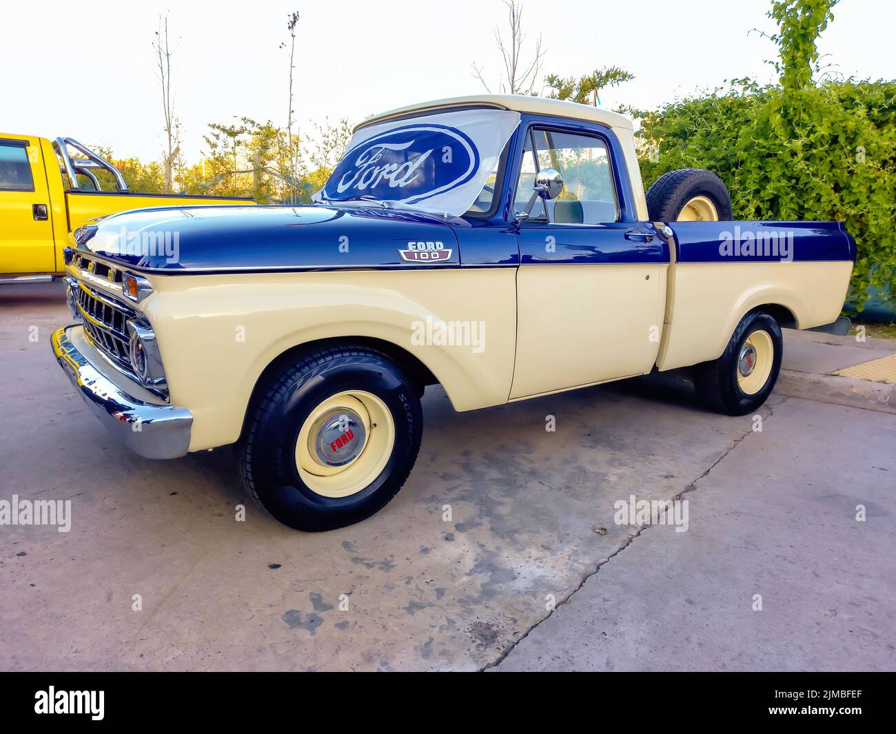 Ford blue oval logo and brand on the windshield of an old F100 V8 utility pickup truck 1963. Side view. Expo Fierro 2022 classic car show Stock Photo