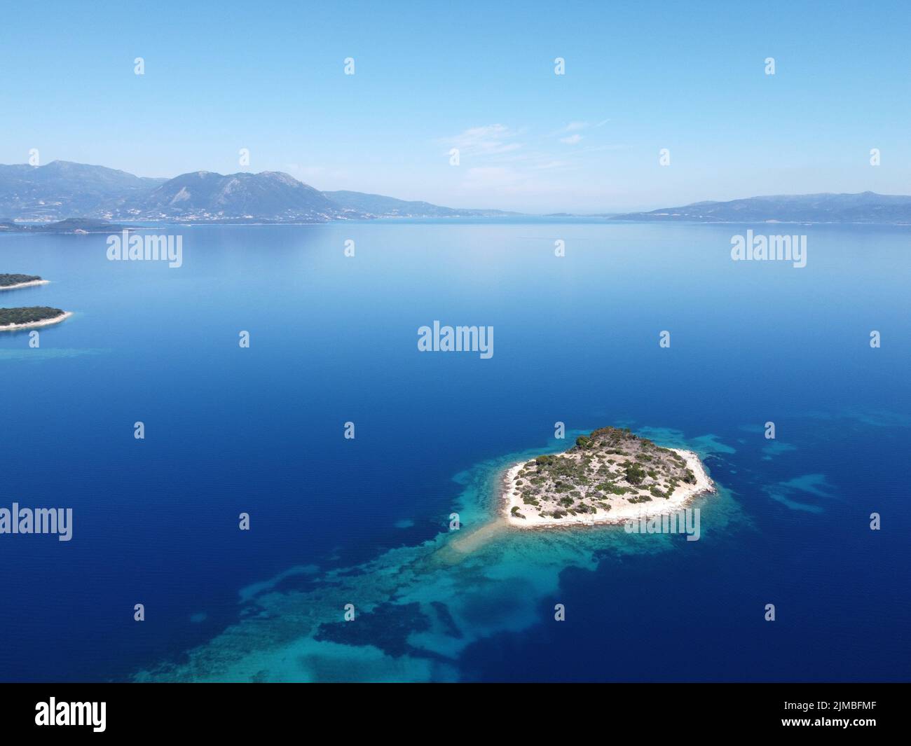 An aerial view of small island in the middle of blue ocean Stock Photo ...
