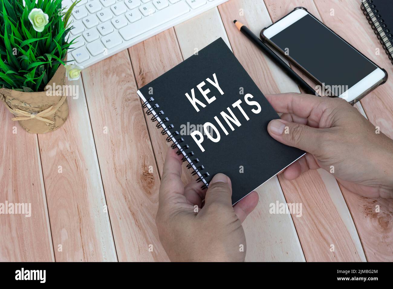 Businessman holding a notepad with key points text. Business concept. Stock Photo