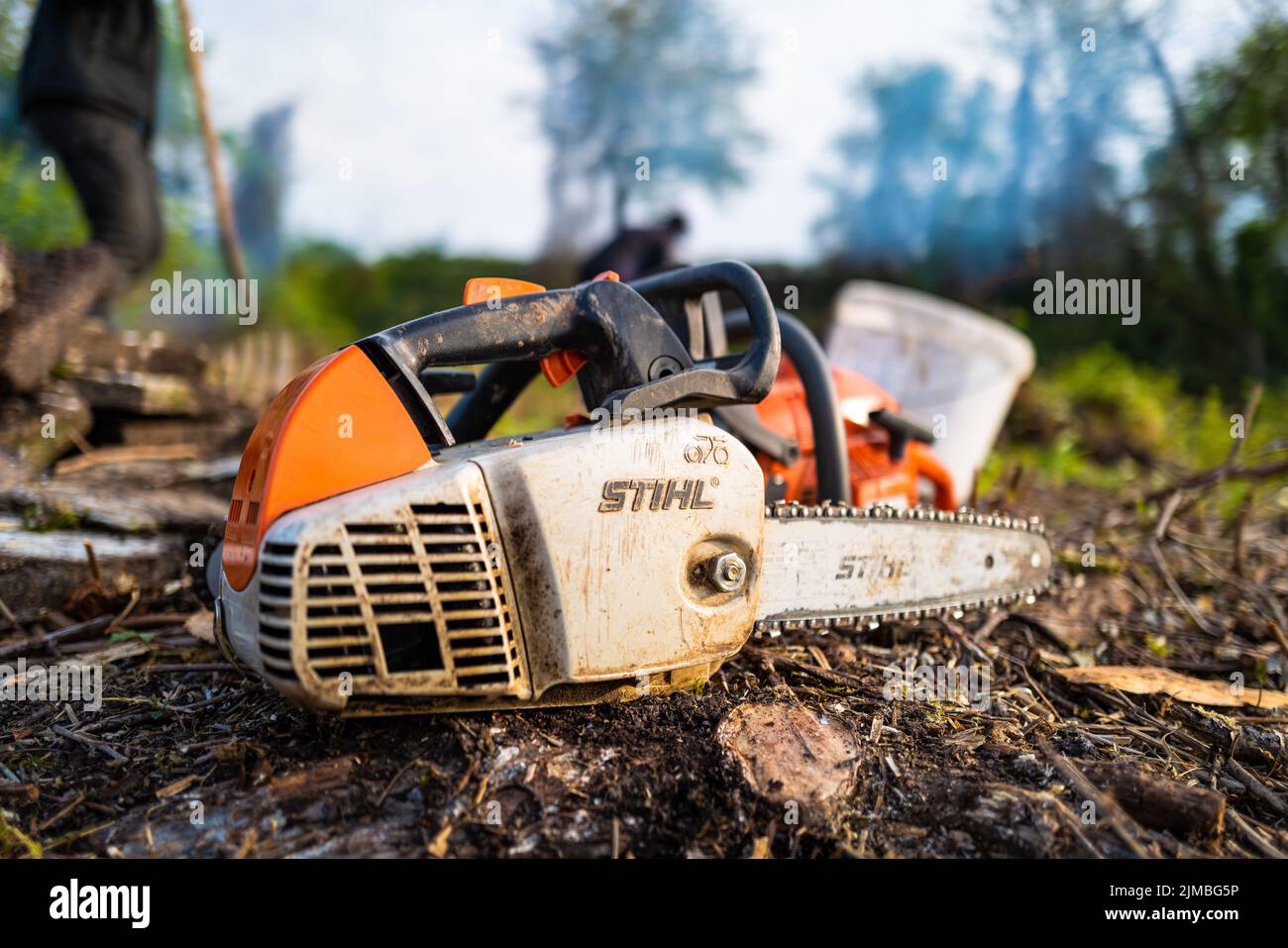 A chainsaw on the ground Stock Photo - Alamy