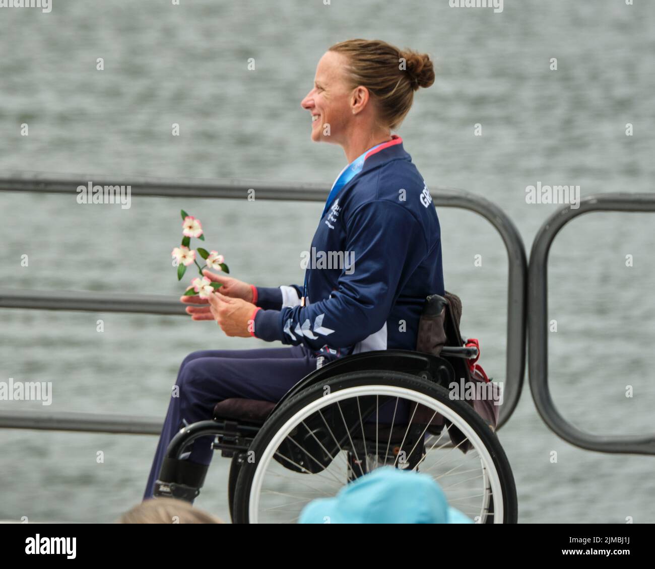 Dartmouth, Canada. August 5th, 2022. Emma Wiggs from Great Britain during the National Anthems as she receives her Gold Medal in the Women Paracanoe VL3 200m World Championships race. This is Wiggs tenth world title to date. Brianna Hennessy from Canada takes Silver and Jeanette Chippington from Great Britain takes bronze. The 2022 ICF Canoe Sprint and Paracanoe World Championships takes place on Lake Banook in Dartmouth (Halifax). Credit: meanderingemu/Alamy Live News Stock Photo