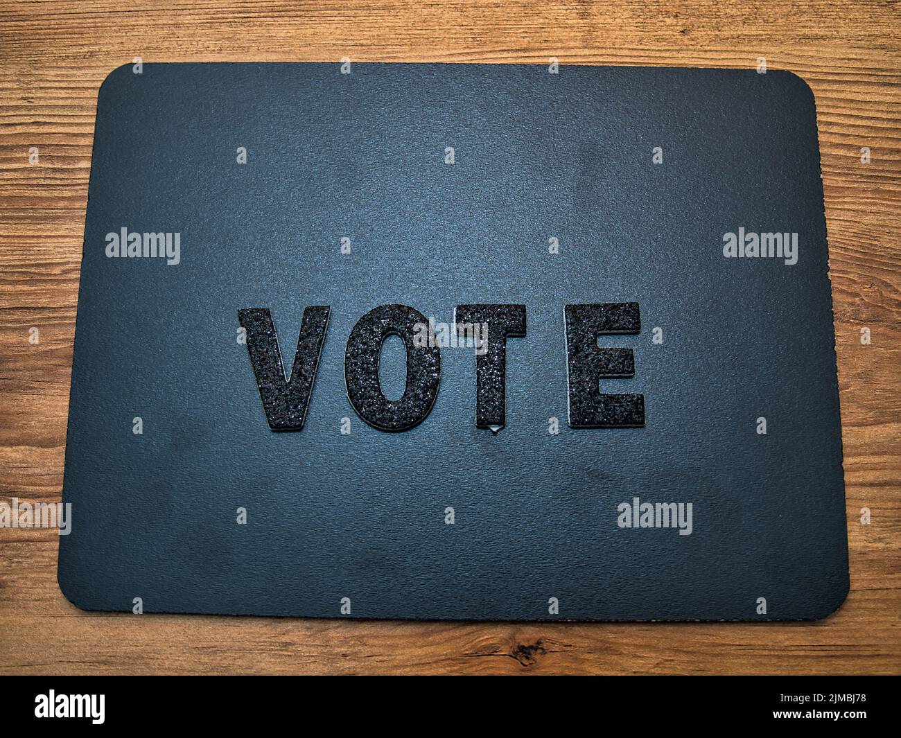 The word Vote in black letters on a black chalkboard background. Perfect for your election day social media posts. Stock Photo