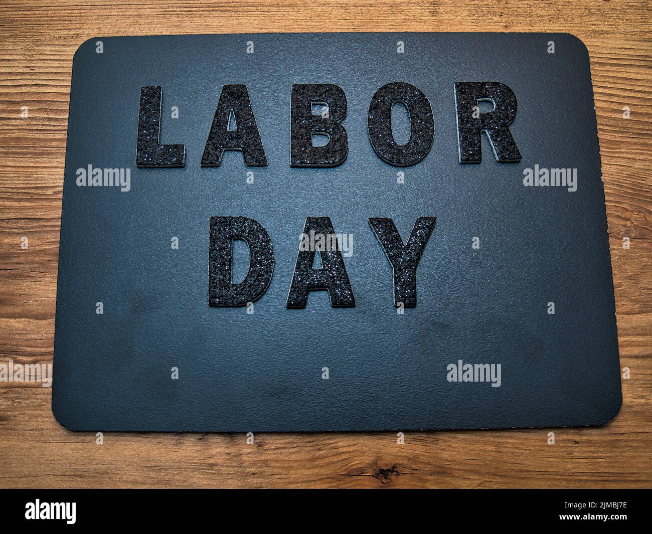 The words Labor Day in black letters on a black chalkboard background