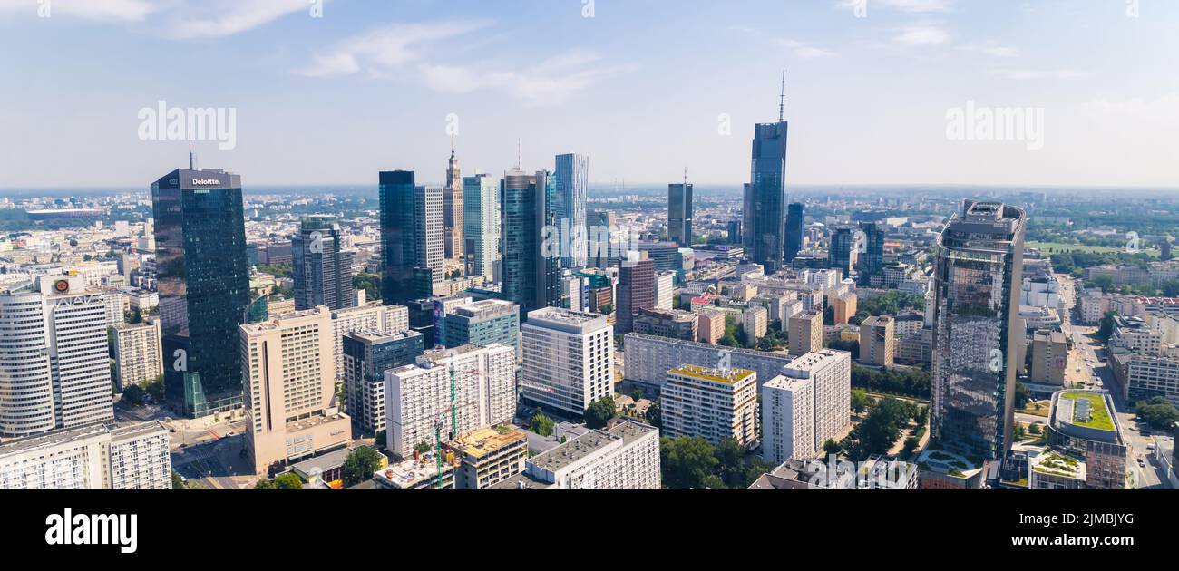 7.22.2022 Warsaw, Poland. Wide panoramic drone shot. Variety of skyscrapers in Warsaw skyline. Social realism represented by Palace of Culture and Science blocked out by neomodern skyscrapers. High quality photo Stock Photo