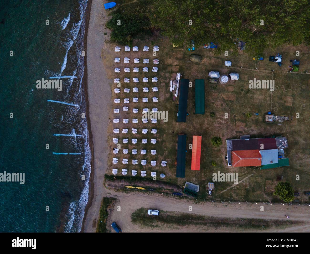 The bird's eye view of sun loungers and campsite by the sea. Stock Photo