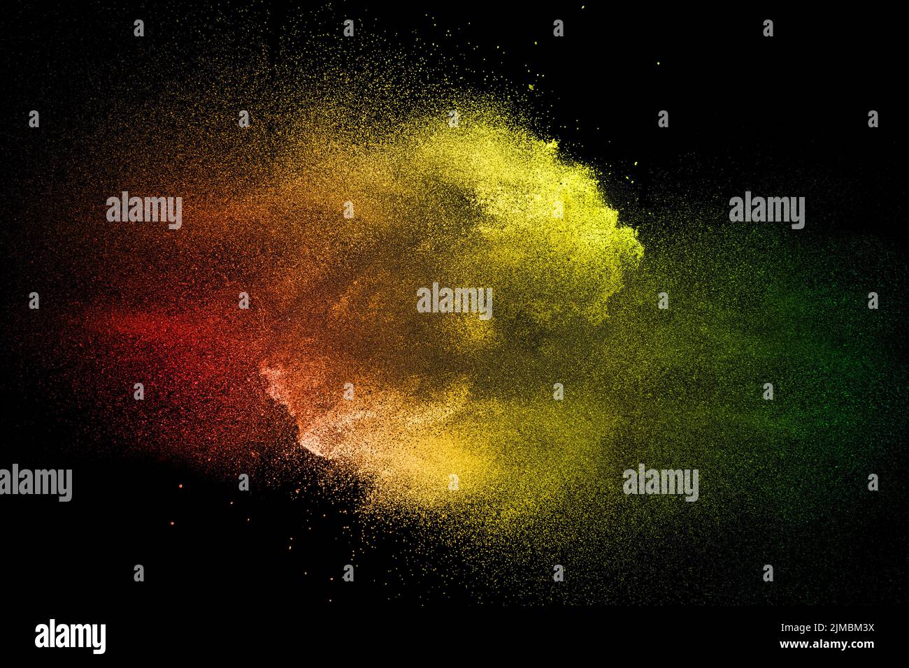 Colored dust splash cloud  on dark background. Launched yellow red particles on background. Stock Photo