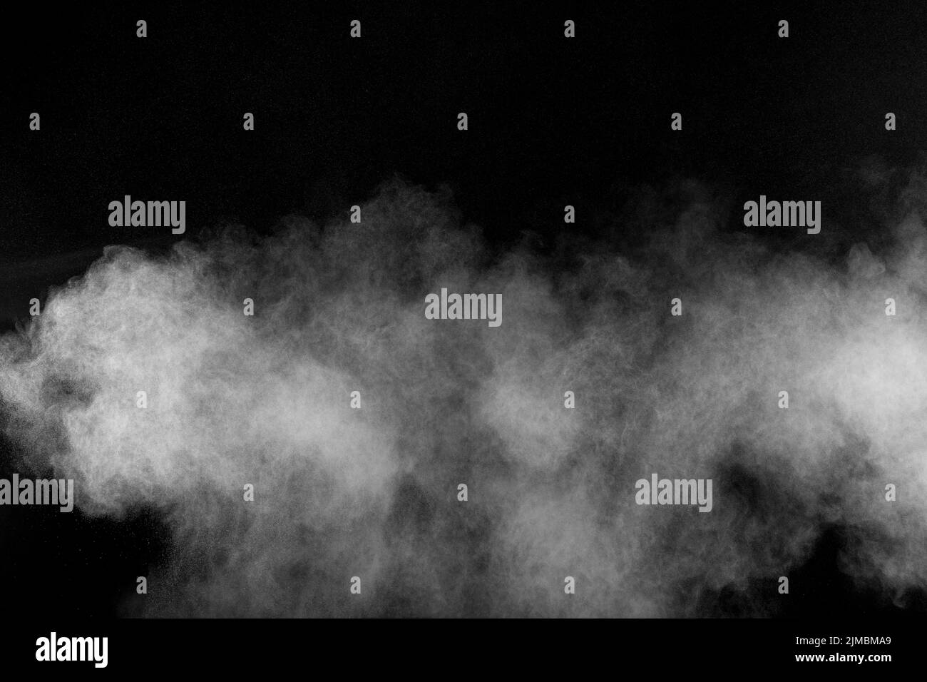 Abstract white powder explosion against black background.Abstract white