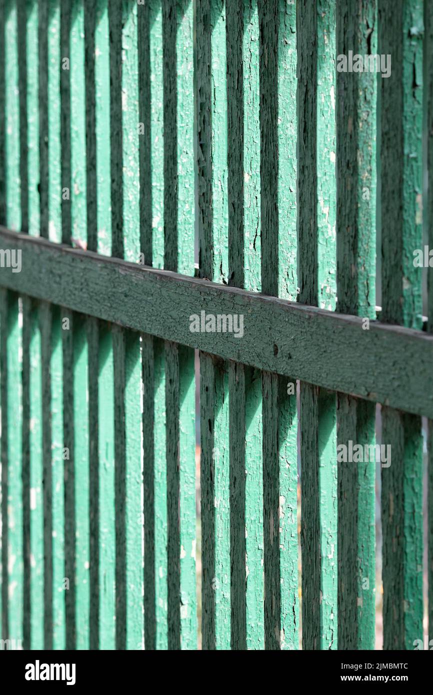 Texture of an old green fence from a fence close up Stock Photo
