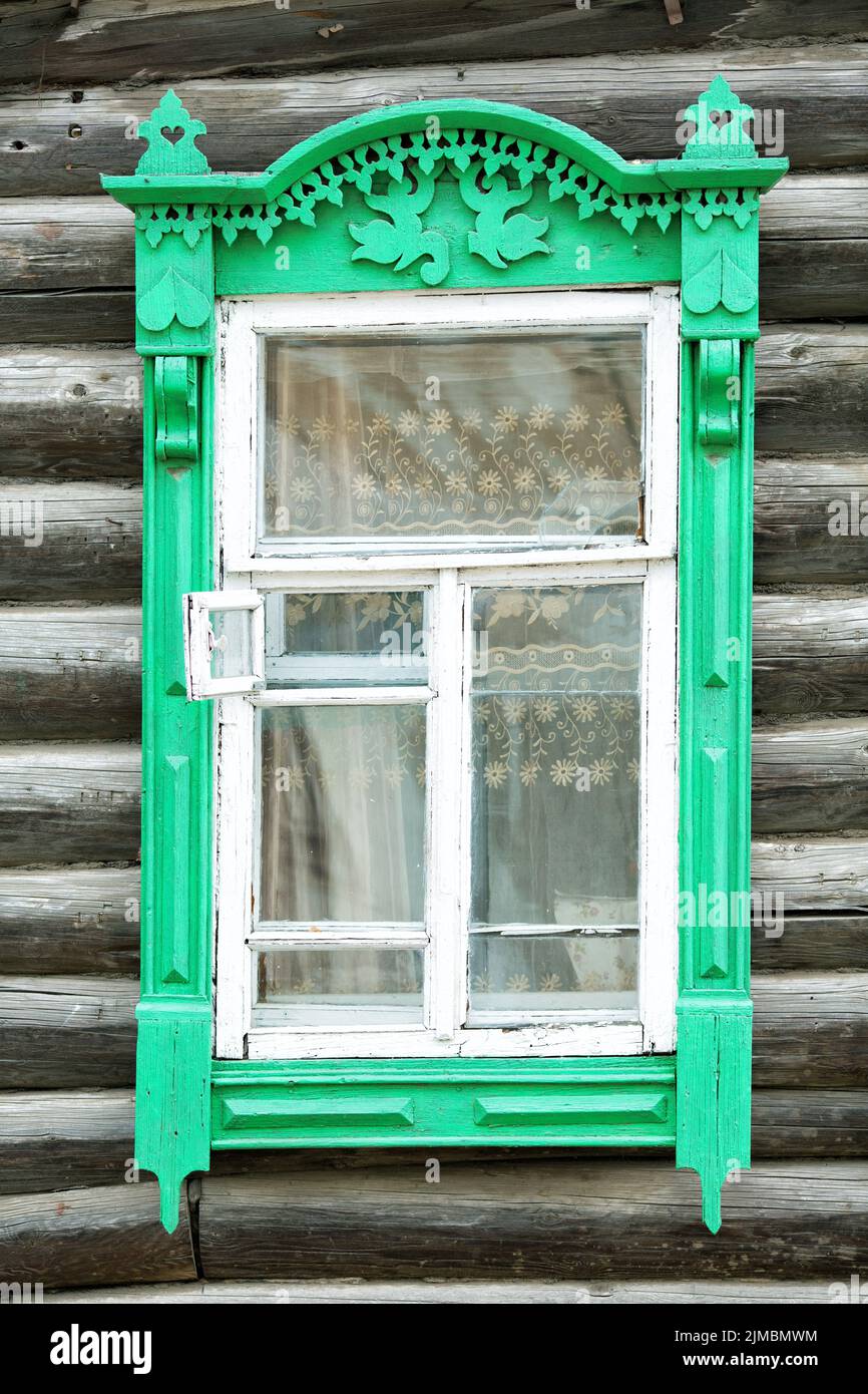 Wooden window and log wall of an old house Stock Photo