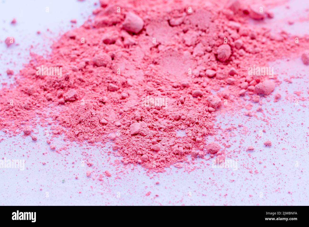 Pink color background of chalk powder. Pink color dust particles splattered on white background. Stock Photo