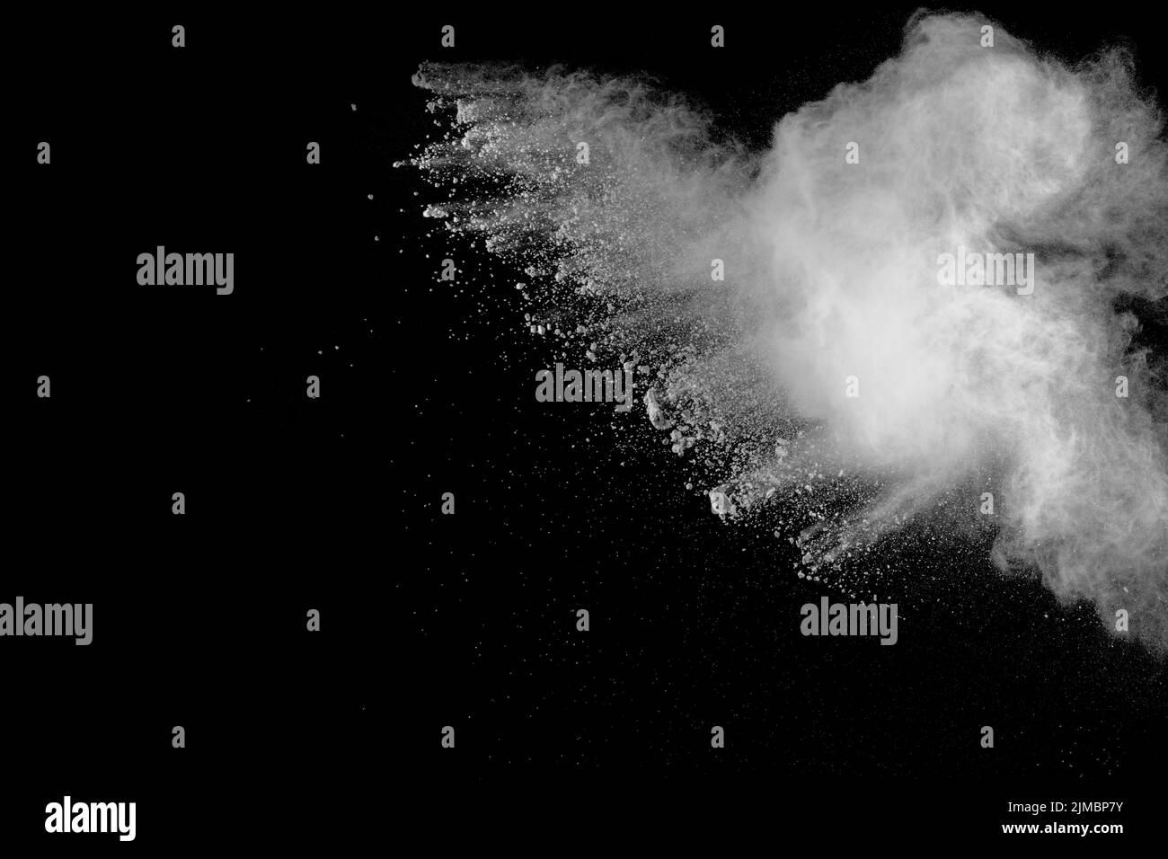 White powder explosion isolated on black background. White dust
