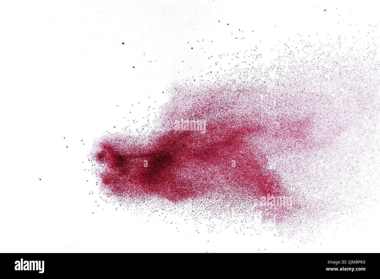 Abstract red dust splattered on white background. Red powder explosion.Freeze motion of red particle Stock Photo