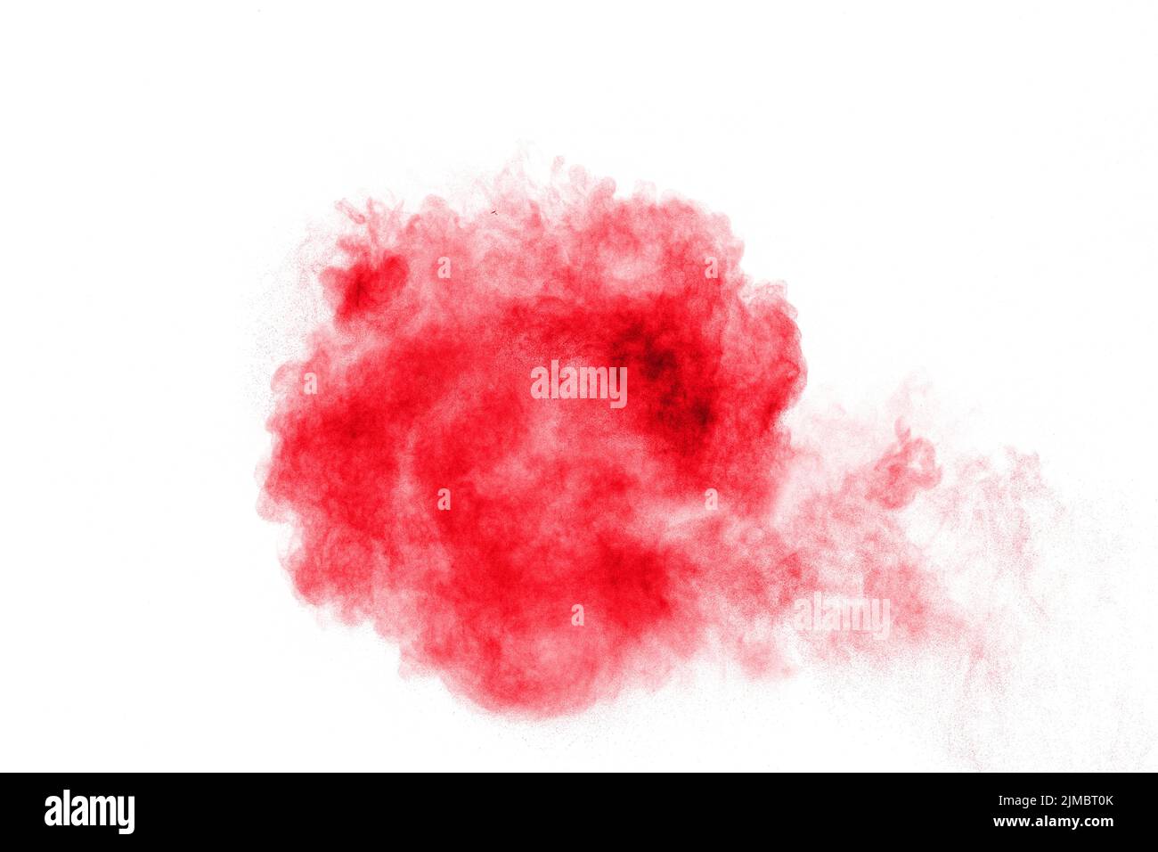 Abstract red dust explosion on white background. Abstract red powder splattered on white  background Stock Photo