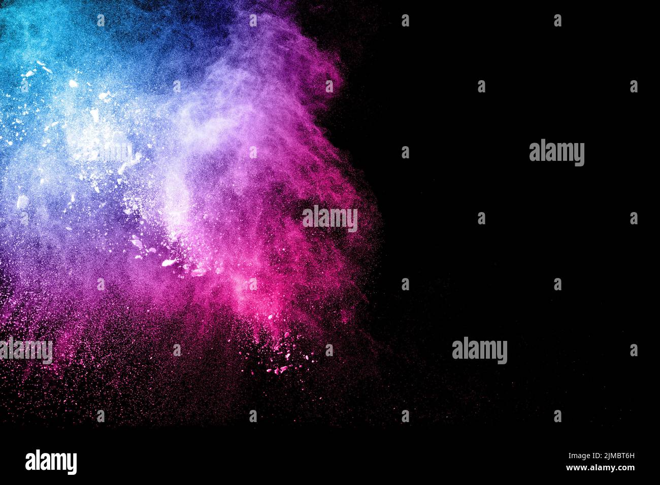 Abstract multi color powder explosion on black background. Freeze motion of colorful dust