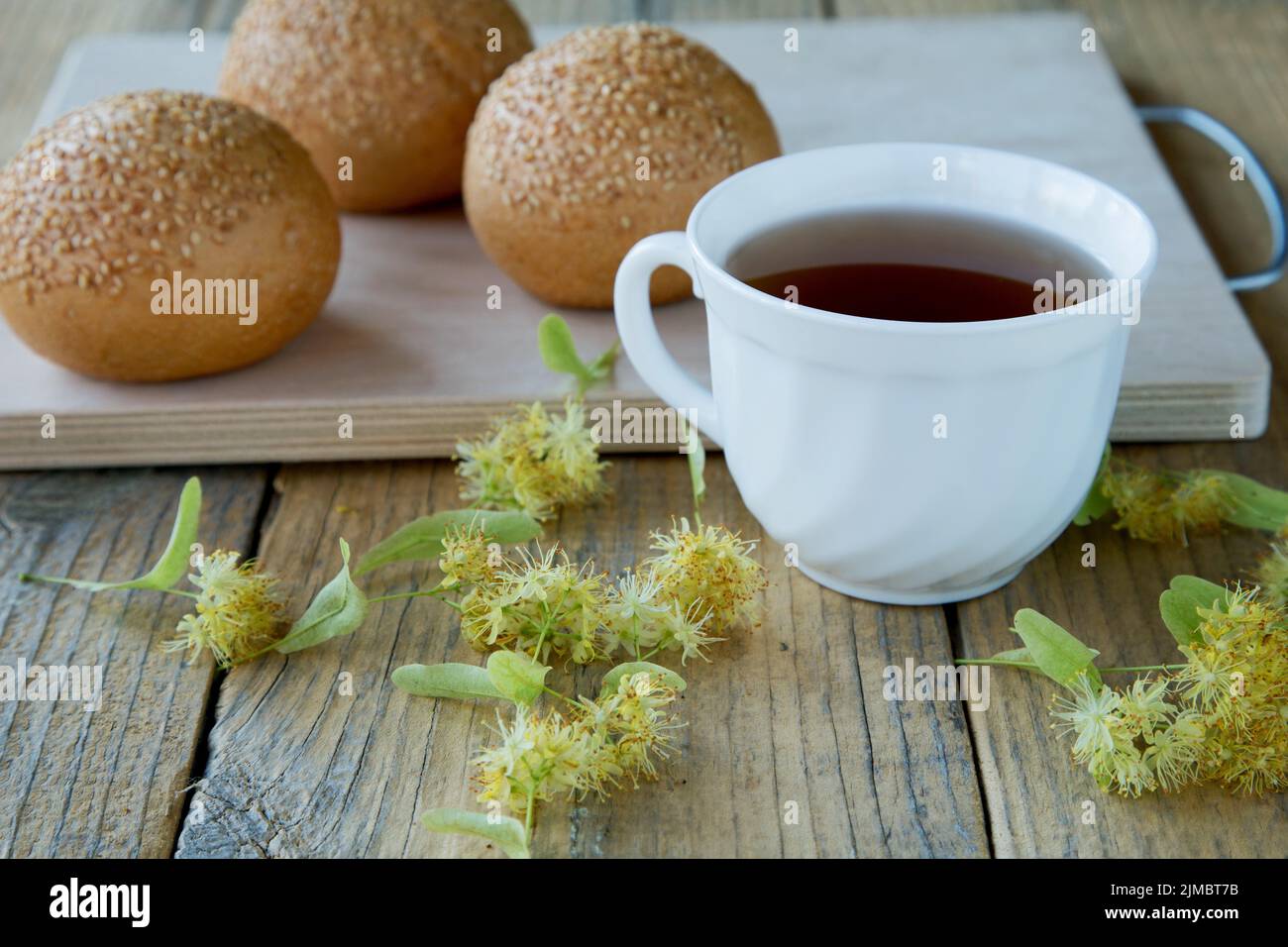 Cup of tea with linden flowers on a rustic table Stock Photo
