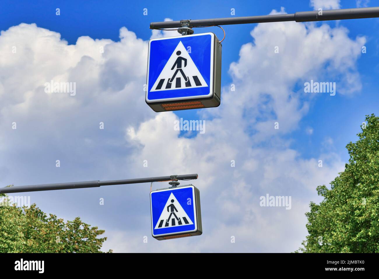 Zebra pedestrian crossing street traffic signs in front of sky Stock Photo