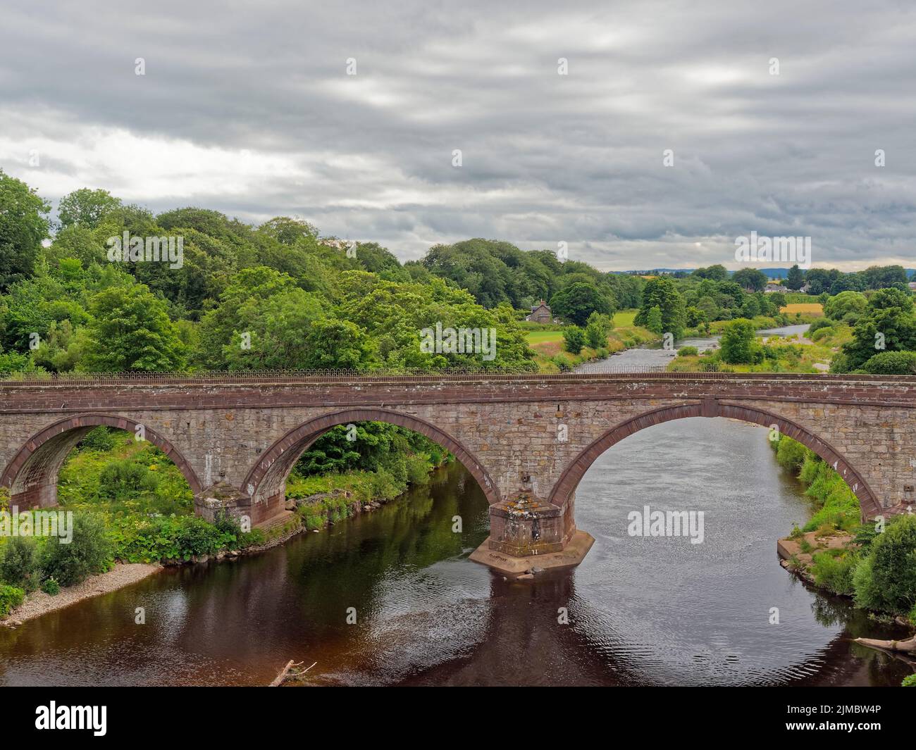 The Lower North Water Bridge on the Road to St Cyrus in Aberdeenshire on a Summers evening with low clouds above. Stock Photo