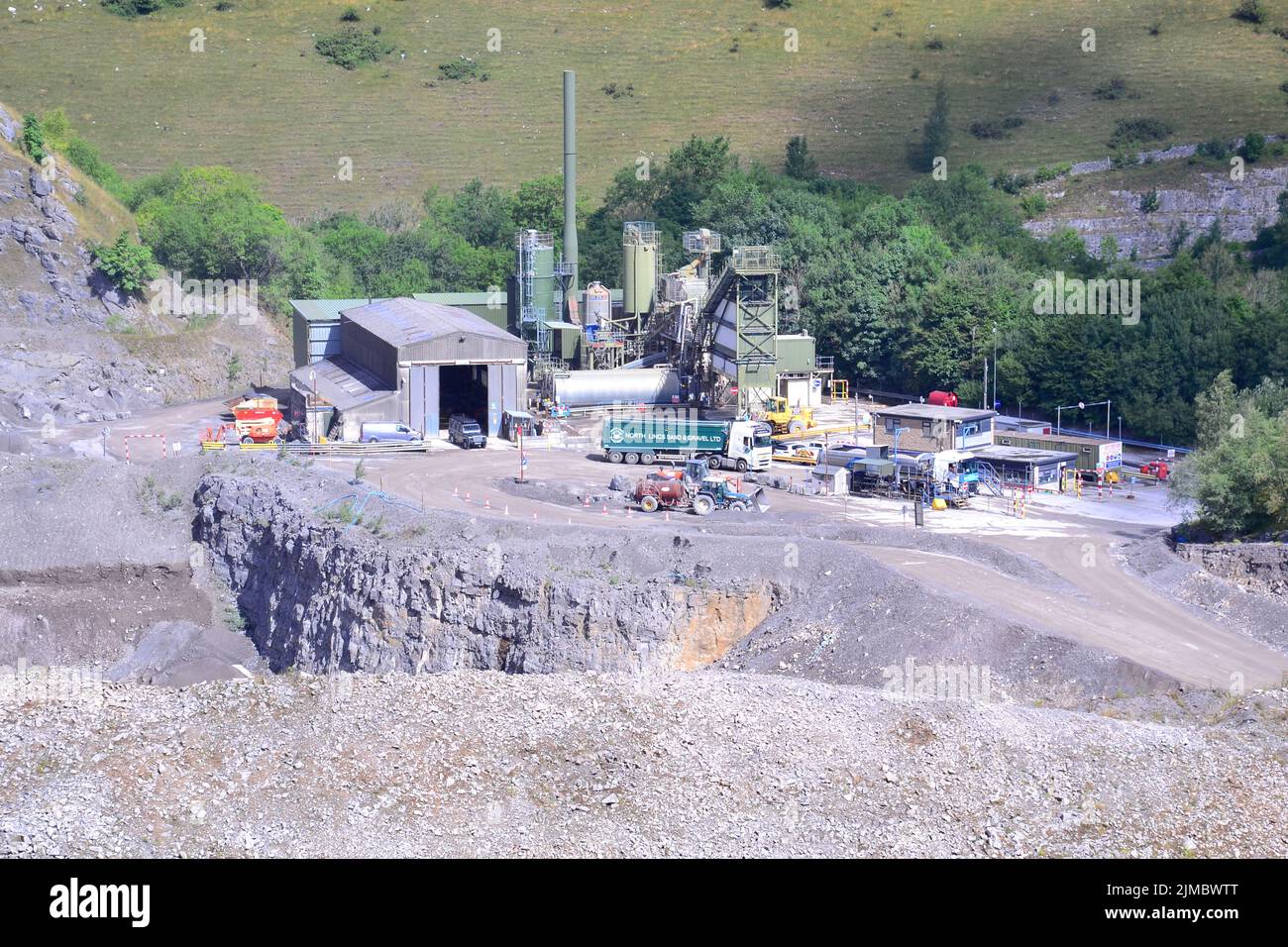 Overhead view an  Aggregate Industries site beside Topley Pike Quarry, a large limestone quarry at the north west end of Deep Dale, Derbyshire, England, United Kingdom, inside the Peak District National Park. Stock Photo