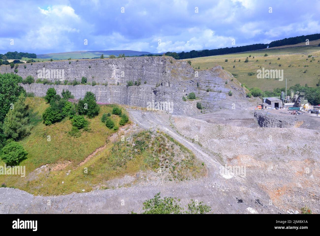 Overhead view of Topley Pike Quarry, a large limestone quarry at the north west end of Deep Dale, Derbyshire, England, United Kingdom, inside the Peak District National Park, with Aggregate Industries site on the right. Stock Photo