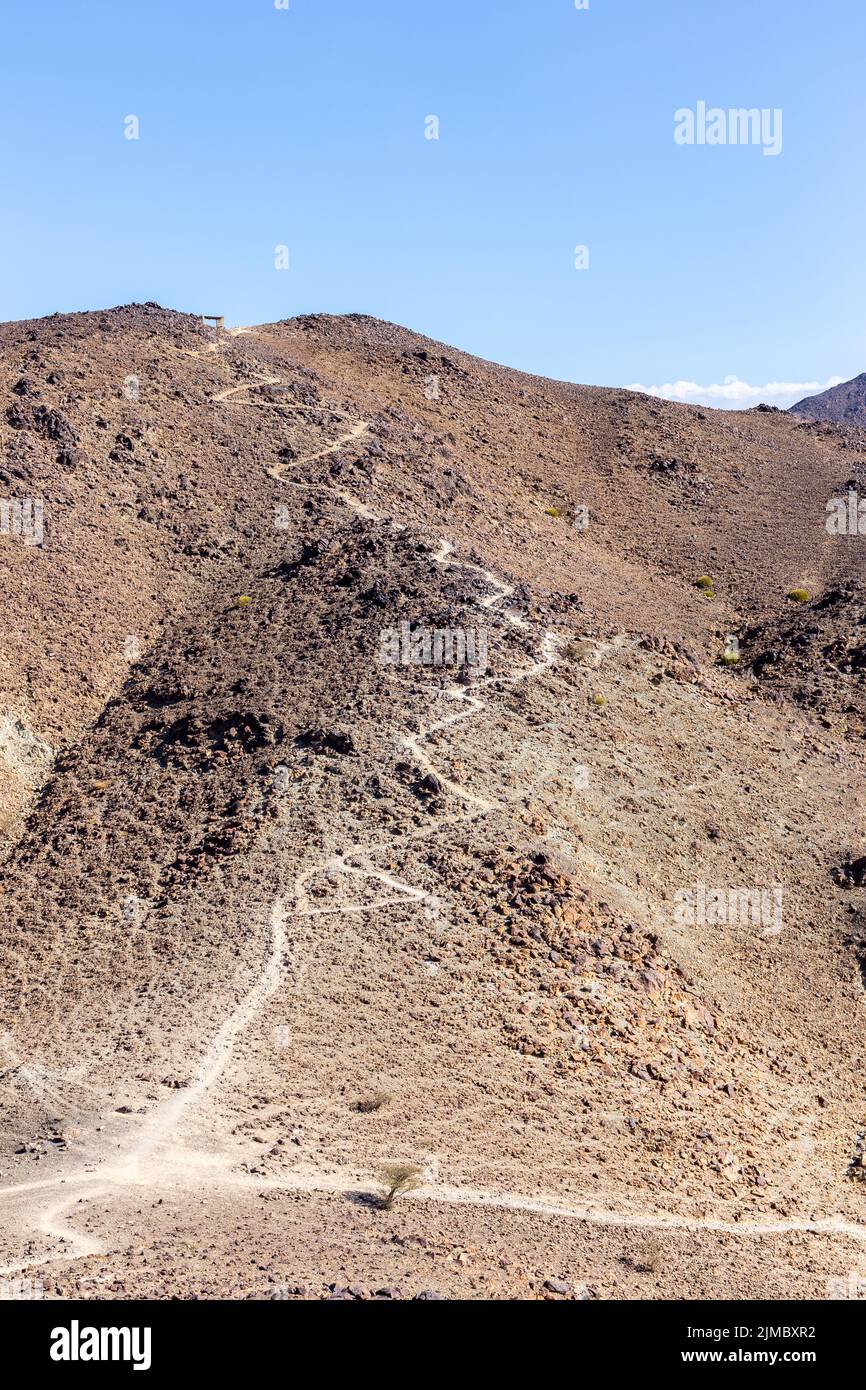 Wadi Shawka Dam trails with winding footpaths towards the top of the mountain, Hajar Mountains, United Arab Emirates. Stock Photo