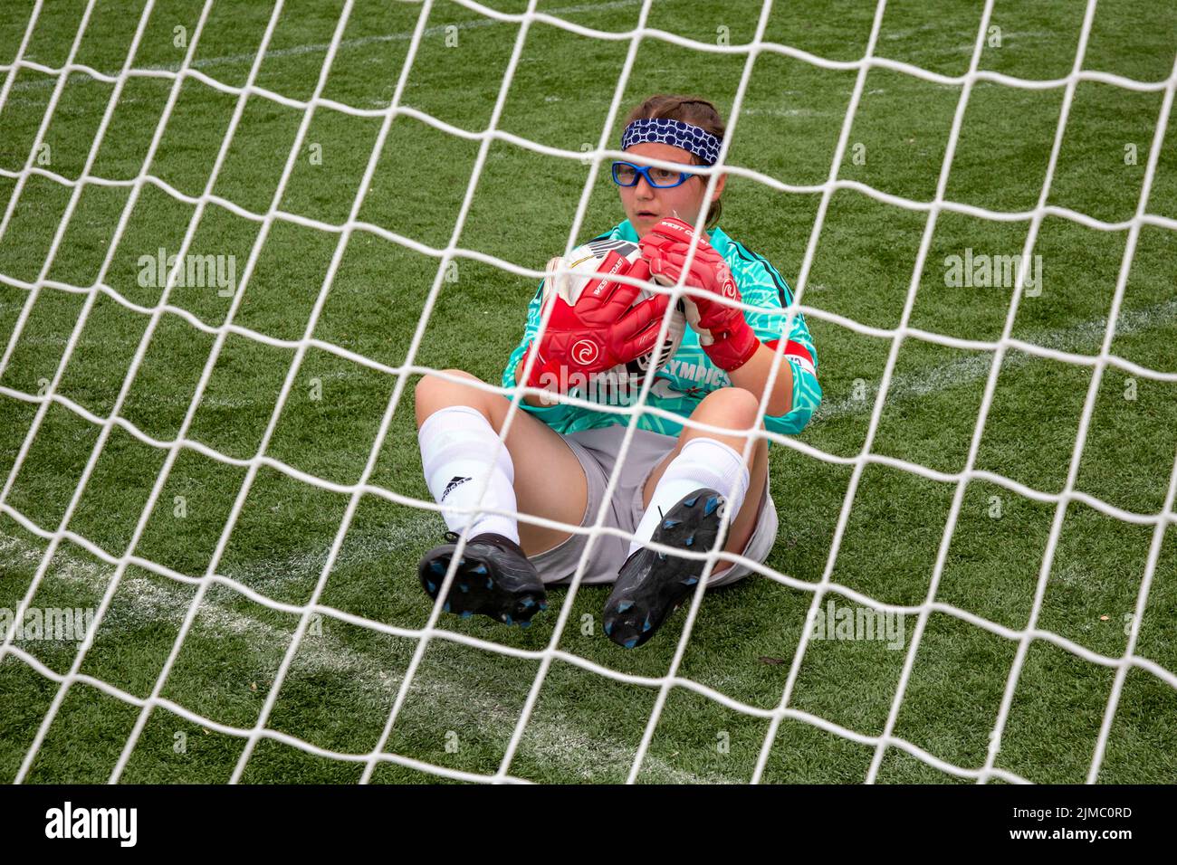 Detroit, Michigan - The U.S. goal keeper cradles the ball after making a save during a match between the women's teams of the United States and Mexico Stock Photo