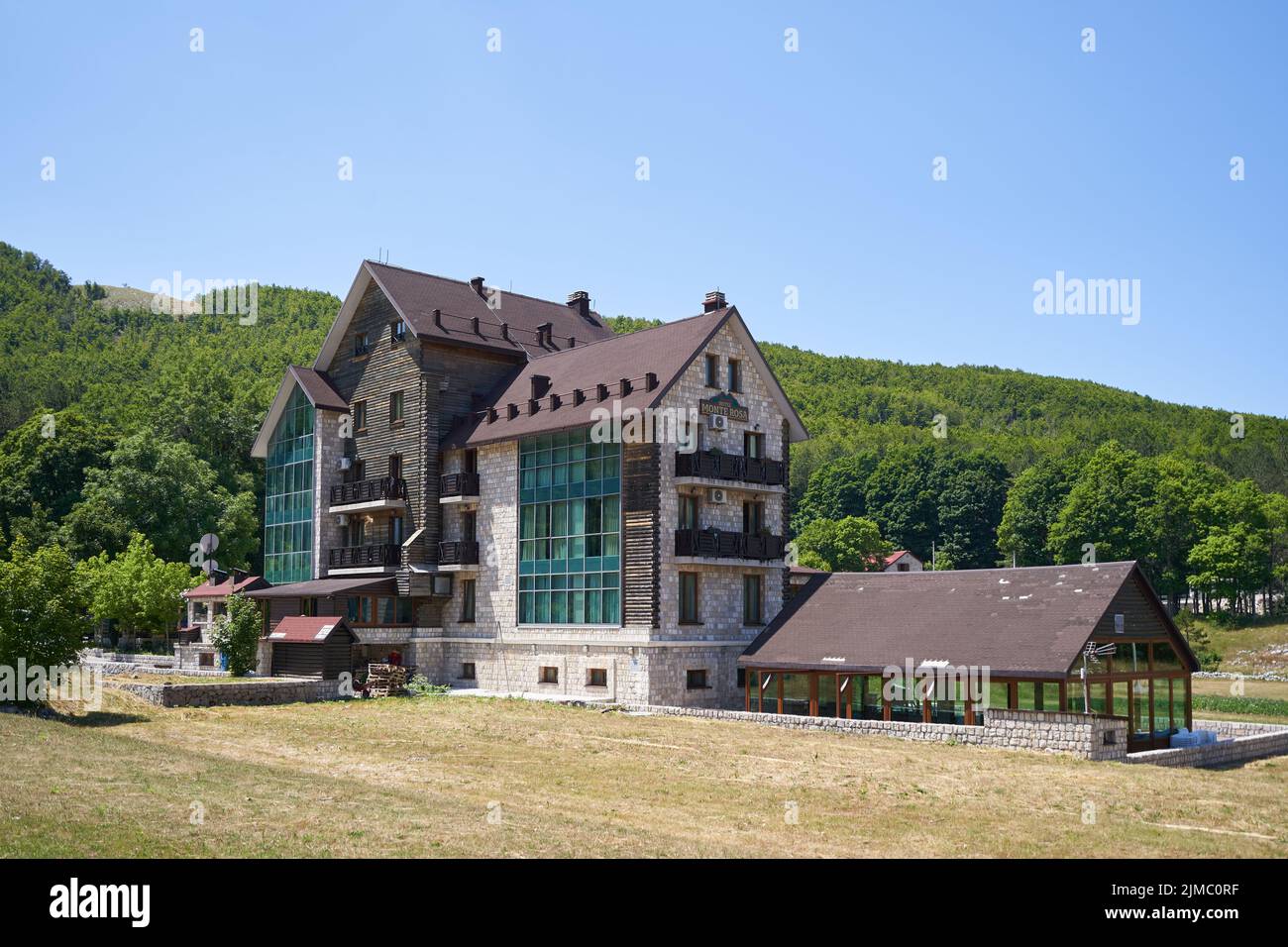 Monte Rosa country hotel against forest Stock Photo