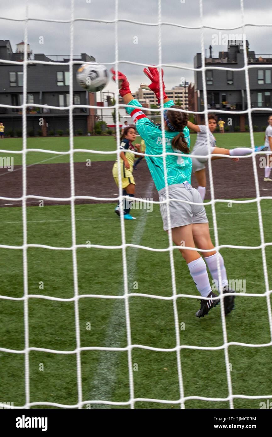 Detroit, Michigan - The U.S. goal tender makes a save as the women's teams of the United States and Mexico meet in the Special Olympics Unified Cup fo Stock Photo