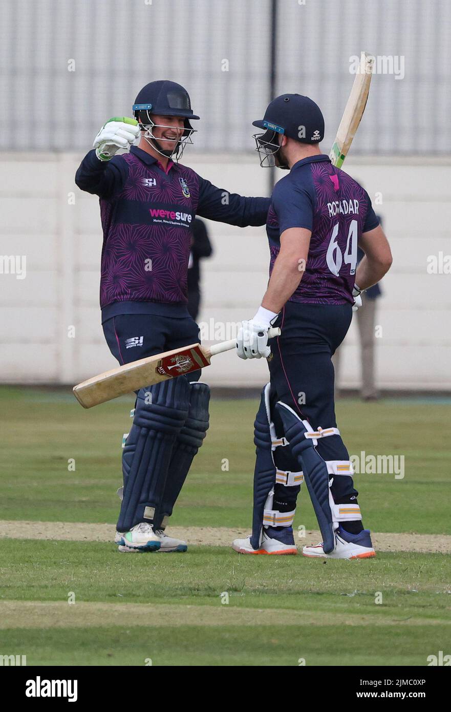 The Green, North Down CC, Comber, County Down.Northern Ireland.  05 Aug 2022. The Gallagher Challenge Cup Final - CIYMS v CSNI (light blue/navy). CIYMS won the cup with a ten wicket victory. Batters Chris Dougerty (left) and Ross Adair celebrate their win. Credit: David Hunter/Alamy Live News. Stock Photo