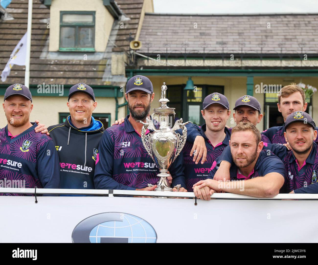 The Green, North Down CC, Comber, County Down.Northern Ireland.  05 Aug 2022. The Gallagher Challenge Cup Final - CIYMS v CSNI (light blue/navy). CIYMS won the cup with a ten wicket victory. CIYMS captain Nigel Jones with the cup and fellow team members. Credit: David Hunter/Alamy Live News. Stock Photo