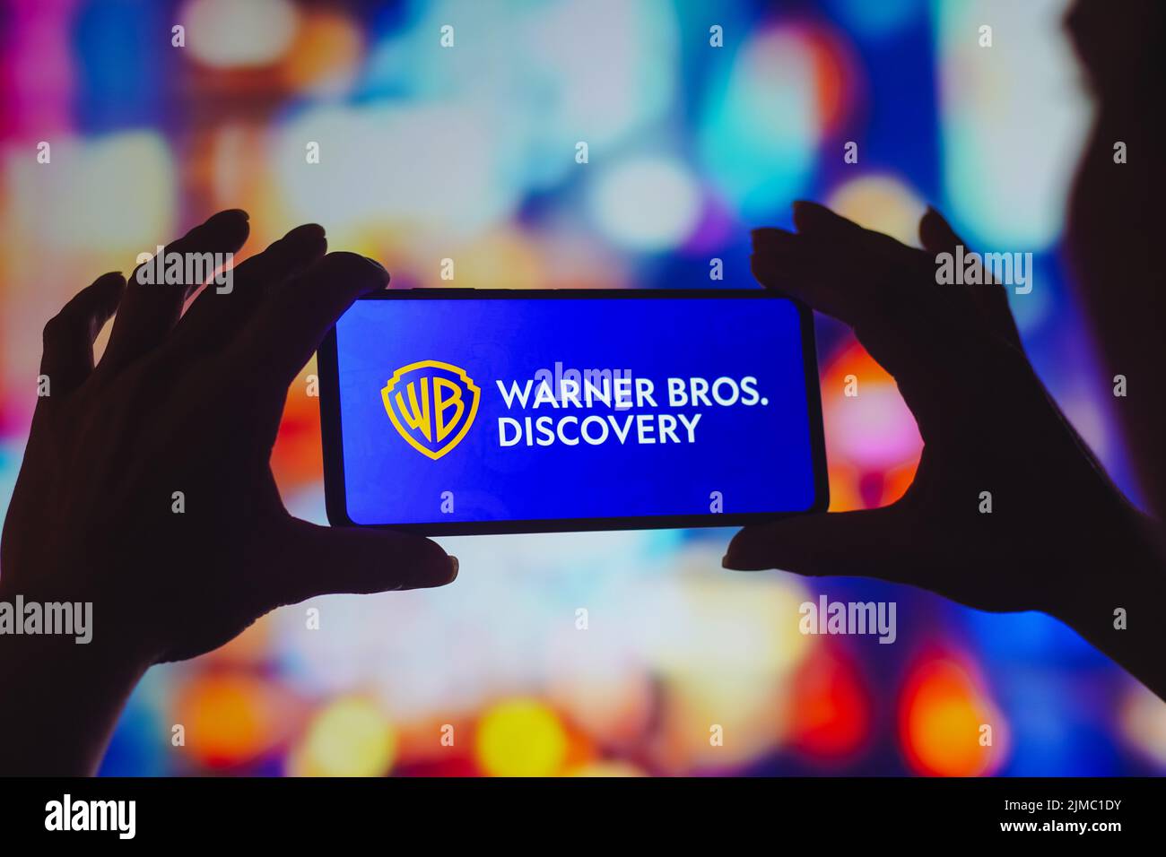 In this photo illustration, the Warner Bros. Discovery logo is displayed on a smartphone screen. Stock Photo