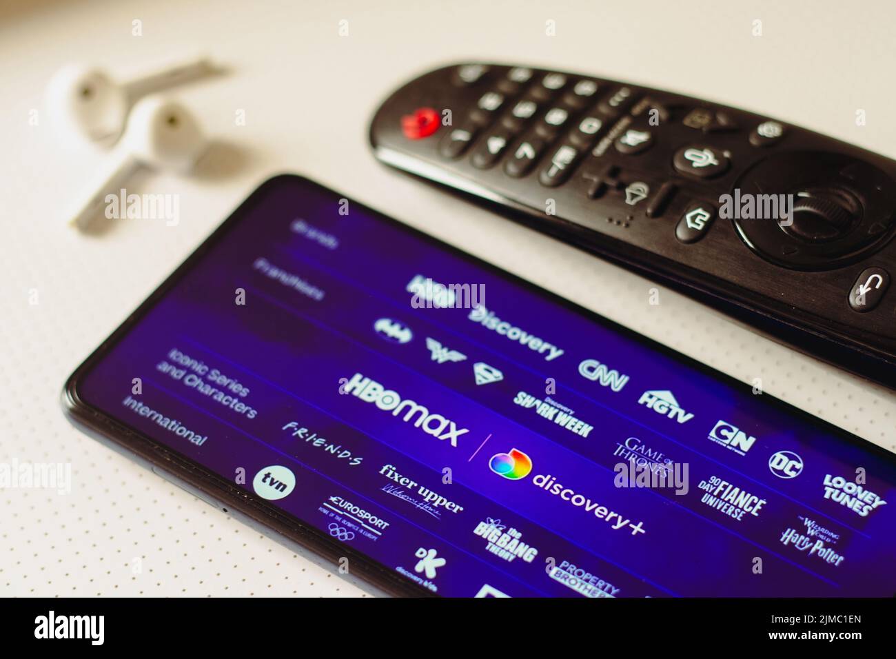 In this photo illustration, the HBO Max and Discovery Plus logos is ...