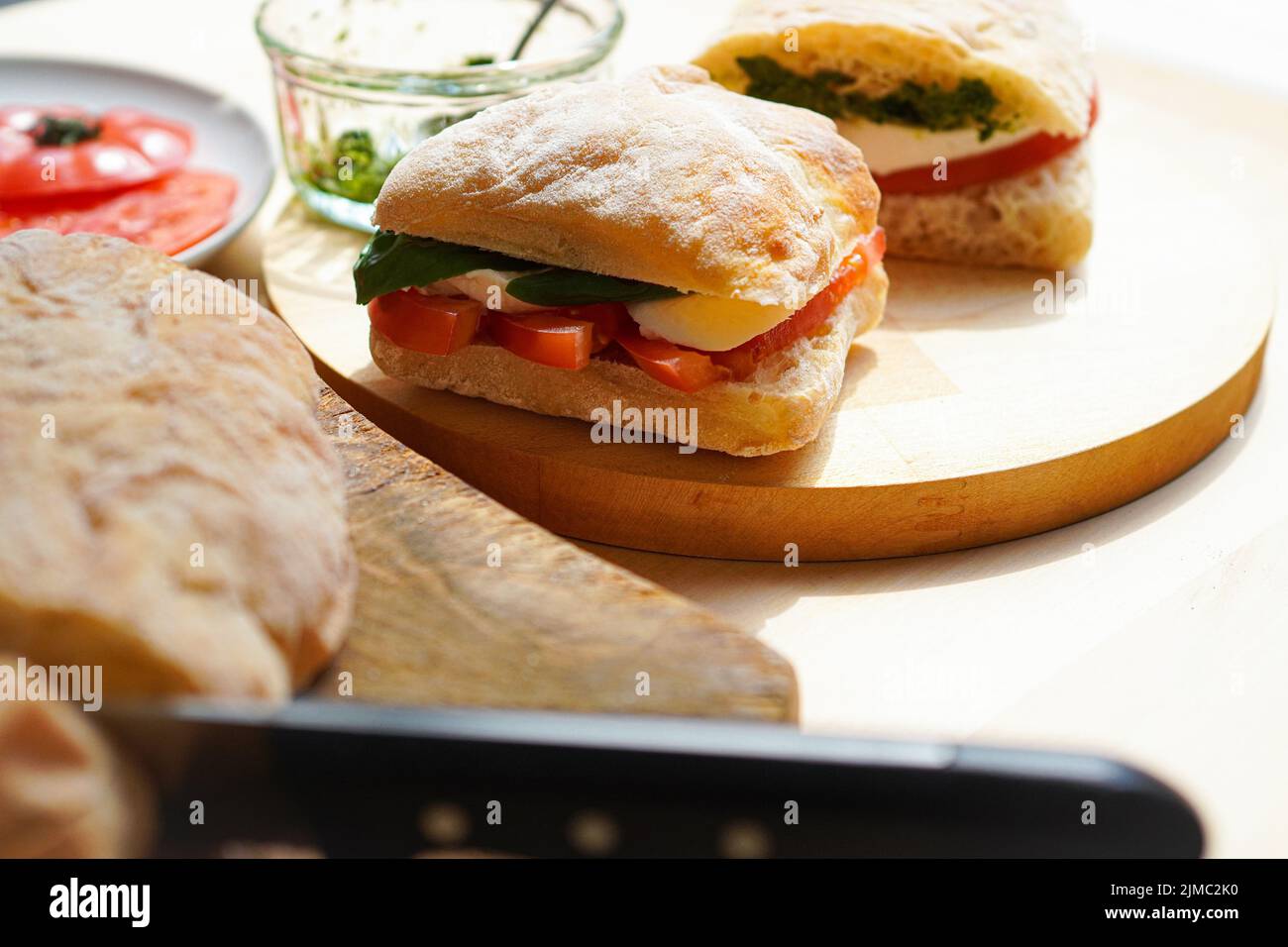 Making Italian panini sandwich with tomato and mozzarella cheese Stock Photo