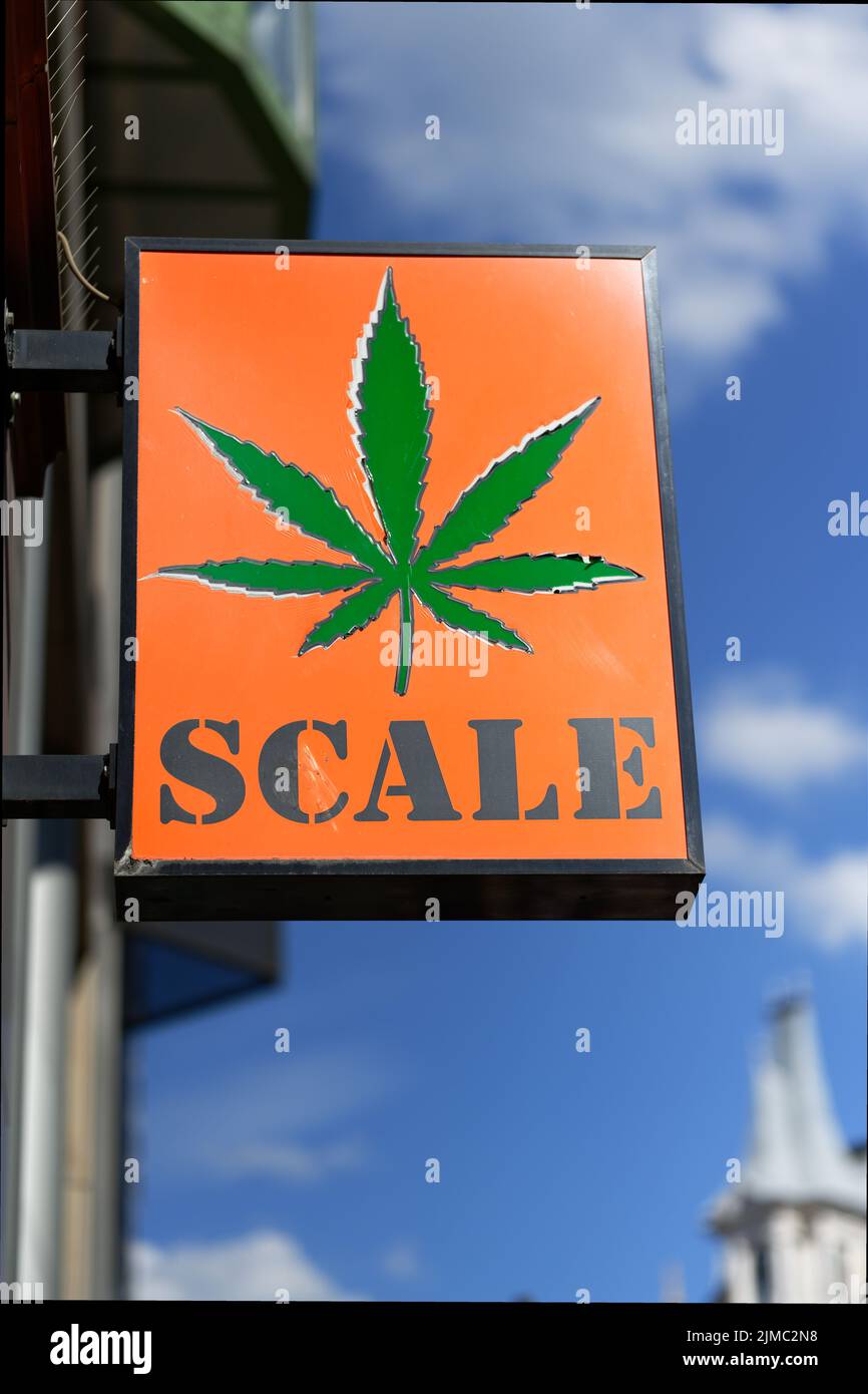 Cologne, Germany, August 03, 2022: Scale headshop advertising sign with a hemp leaf at Ehrenstrasse in Cologne Stock Photo