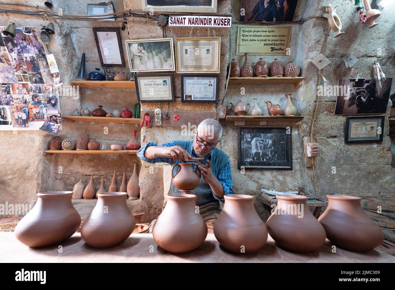 29 June 2022, Turkey, Avanos Potter Mehmet Körükcü sits at a potter's