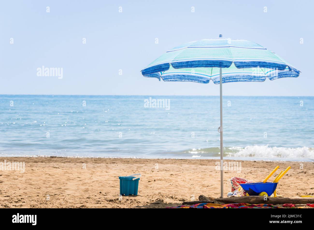 Umbrella beach and children beach toys Stock Photo Alamy