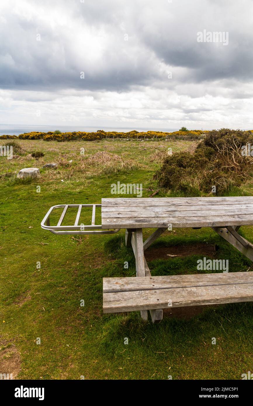 Picnic bench with metal shelf to hold disposable, portrait, copyspace at top Stock Photo