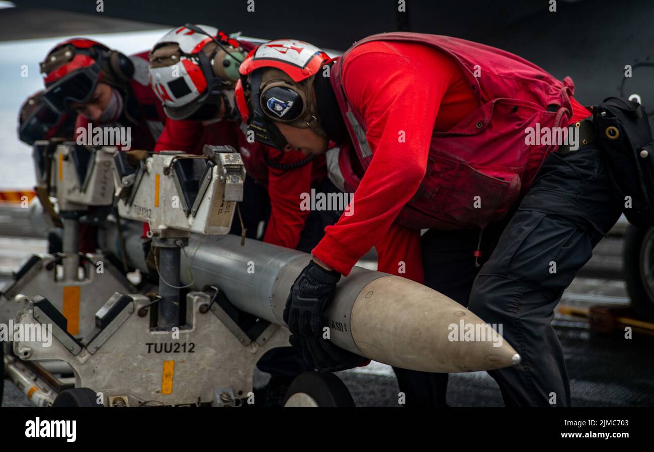 Pacific Ocean, United States. 04th Aug, 2022. U.S. Navy sailors load ordnance onto an F/A-18E Super Hornet attached to the “Dambusters” of Strike Fighter Squadron 195, on the flight deck of the Nimitz-class aircraft carrier USS Ronald Reagan underway, August 4, 2022 in the Philippine Sea. Credit: MC3 Gray Gibson/Planetpix/Alamy Live News Credit: Planetpix/Alamy Live News Stock Photo