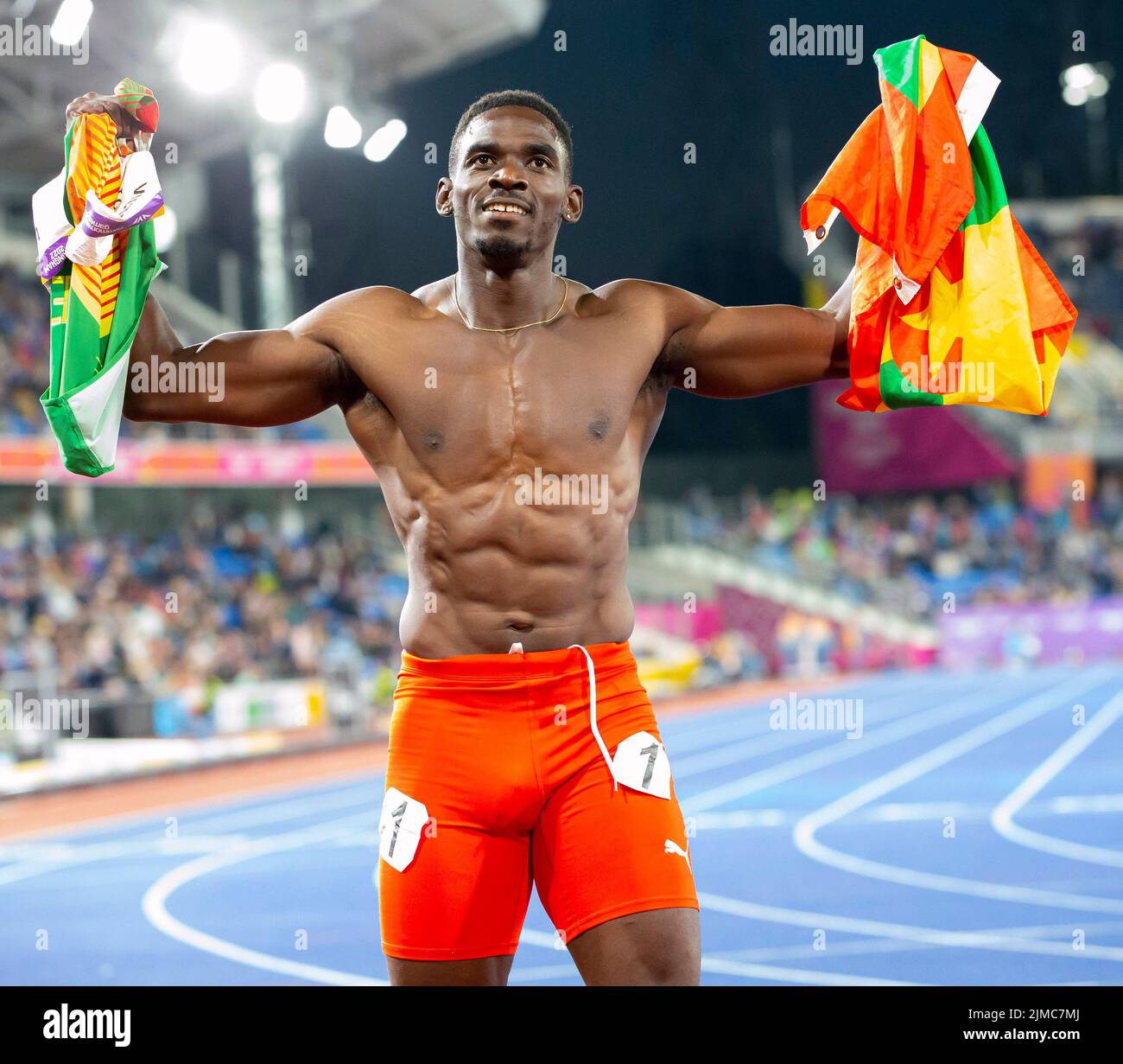 Birmingham, UK. 5th Aug 2022. 5th August 2022; Alexander Stadium, Birmingham, Midlands, England: Day 8 of the 2022 Commonwealth Games: Lindon Victor (GRN) with his national flag and shirtless after winning the Gold Medal in the Men's Decathlon Credit: Action Plus Sports Images/Alamy Live News Stock Photo