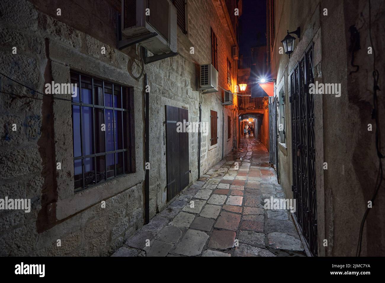 Narrow street of the old town of Kotor at night in Montenegro. Stock Photo