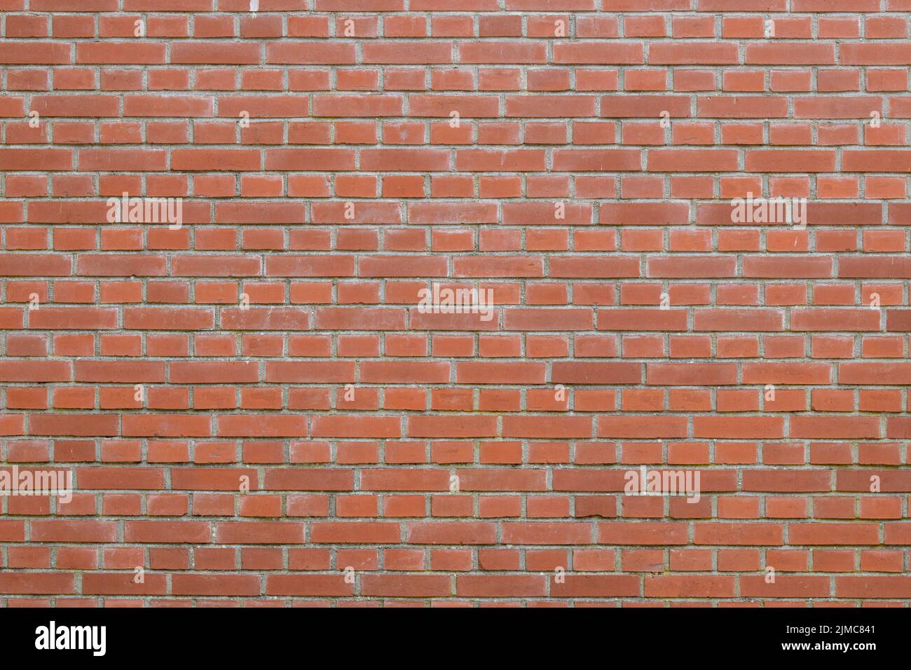 Bricks in an orangered color in chain link regulation Stock Photo Alamy