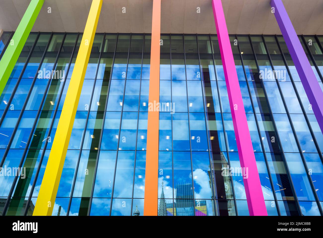Glass fronted modern building with coloured pillars, Birmingham, UK Stock Photo