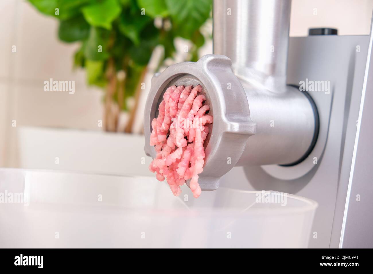 https://c8.alamy.com/comp/2JMC9A1/a-man-processes-meat-in-an-electric-meat-grinder-preparation-of-minced-beef-and-pork-for-cutlets-meatballs-chops-2JMC9A1.jpg